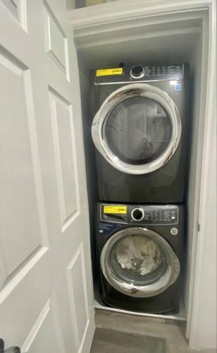 a washer and dryer in a room with a door at Blanquitas Home in Long Beach
