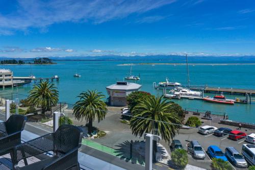 a view of a marina with boats in the water at Penthouse 37 - Nelson Waterfront Apartment in Nelson