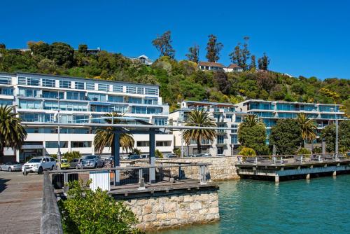 a large building next to a body of water at Penthouse 37 - Nelson Waterfront Apartment in Nelson