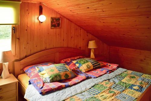 a bedroom with two beds in a wooden cabin at holiday home, Gowidlino in Gowidlino