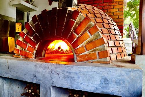 a brick oven with a fire inside of it at Tangalle Rest House in Tangalle