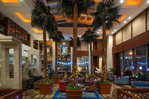 a hotel lobby with palm trees and christmas lights at Chengdu Tianfu Sunshine Hotel in Chengdu