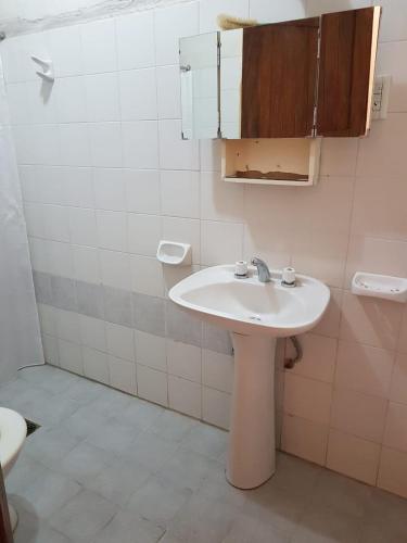 a bathroom with a white sink and a mirror at La Viñita in Cafayate