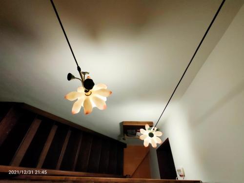 two lights hanging from the ceiling in a room at 新龍頭古厝行館 Shin Long Tou B&B in Jinning