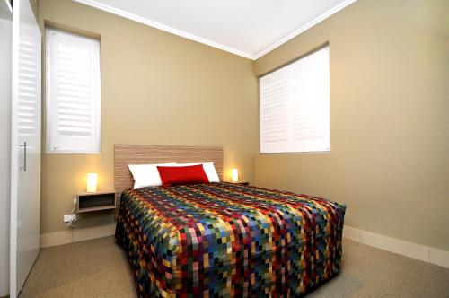 Ένα ή περισσότερα κρεβάτια σε δωμάτιο στο Laguna Serviced Apartments