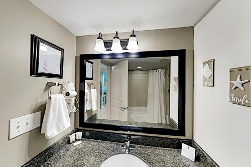 a bathroom with a sink and a large mirror at Oceans One Resort Unit 403 in Myrtle Beach