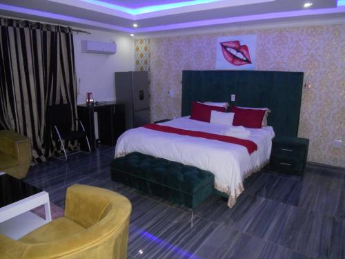 a hotel room with a large bed and a chair at Gold Crown International Hotel With Complementary Breakfast and WiFi in Johannesburg