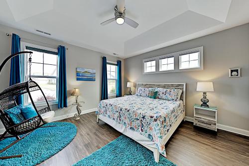 a bedroom with a bed and two windows at The Retreat at Barefoot Village #41 in Myrtle Beach