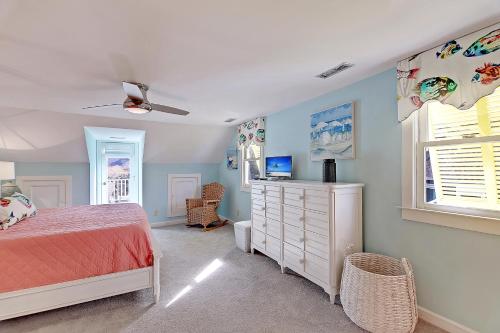 a bedroom with a bed and a dresser and a window at 2714 Bayonne Street in Sullivans Island