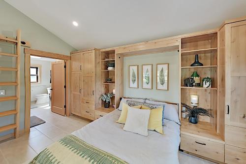 a bedroom with a large bed and wooden cabinets at South Cedar Escape in Tacoma