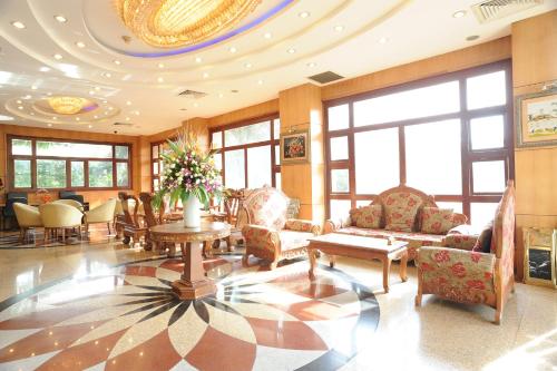 a lobby with chairs and a table in a building at Hoang Yen Hotel in Thuan An