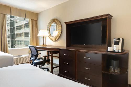 a hotel room with a desk and a television at Crowne Plaza Crystal City-Washington, D.C. by IHG in Arlington