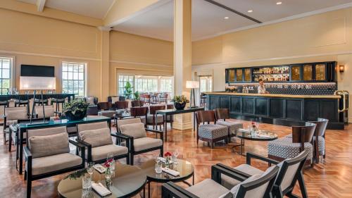 a restaurant with tables and chairs and a bar at InterContinental Sanctuary Cove Resort by IHG in Gold Coast