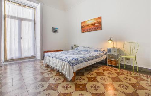 a bedroom with a bed and a table and a chair at La Casa Dei Ricordi in Catania