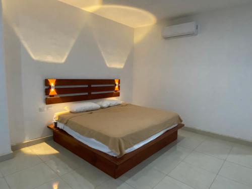 Casa Coronado Izamal في إسامال: غرفة نوم بها سرير مع أضواء عليه