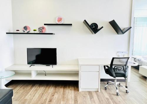 a white desk with a television and a chair at LANDMARK2 - GreenView, QuietSpace, BudgetStay, FreeParking, Near Kajang, SgLong, C180, Cheras in Kajang