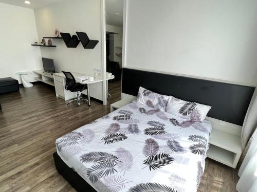 a bedroom with a bed and a desk with a computer at LANDMARK2 - GreenView, QuietSpace, BudgetStay, FreeParking, Near Kajang, SgLong, C180, Cheras in Kajang