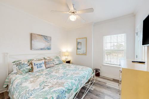 a bedroom with a bed and a ceiling fan at Dauphin Island Beach Club #210 in Dauphin Island