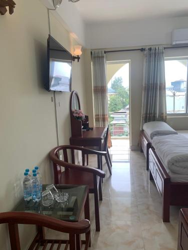a hotel room with a bed and a table with a desk at AD 41 Hotel Huế CS2 in Hue