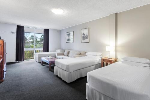 A bed or beds in a room at Dorset Gardens Hotel