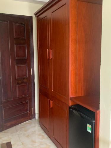 a large wooden cabinet next to a door at AD 41 Hotel Huế CS2 in Hue