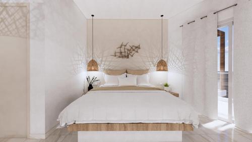 a bedroom with a large bed with white walls at Chouzourakis Studios in Keratokampos