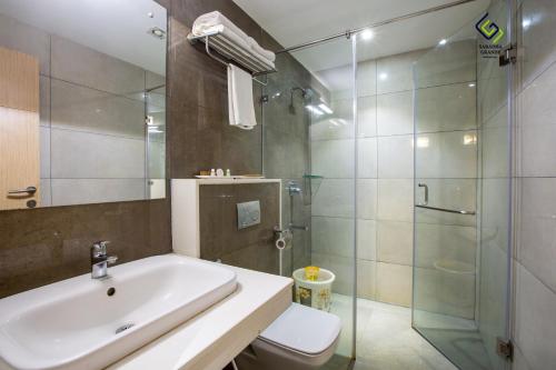 bagno con lavandino e doccia in vetro di Hotel Saradha Grande a Pudukkottai