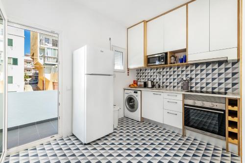 a kitchen with a white refrigerator and a dishwasher at RG Sunny Ap in Faro