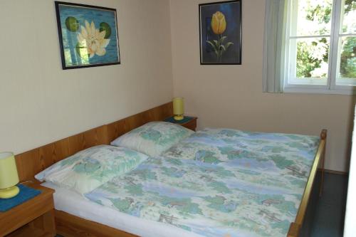 a bed in a bedroom with two pillows on it at Ferienhaus Simon in Pörtschach am Wörthersee