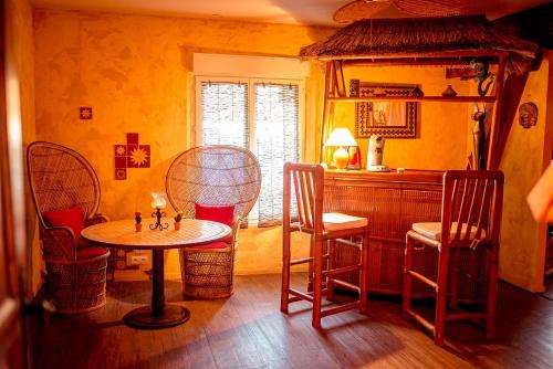 a dining room with a table and chairs in a room at Domaine de la croix du Vexin in Théméricourt