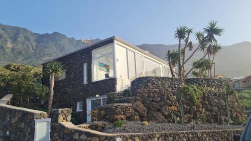a house on top of a rock wall at Casa Villamaravilla II, Isla de El Hierro in Frontera