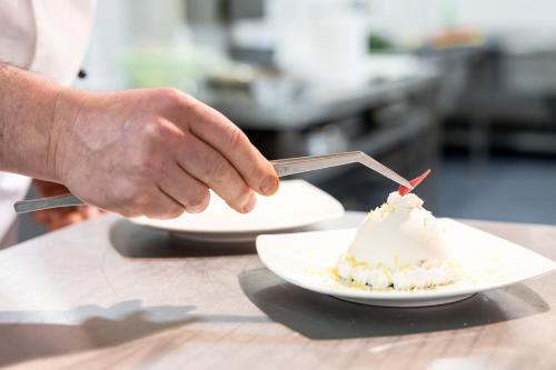 a person is eating a dessert on a table at Aequa Hotel in Vico Equense
