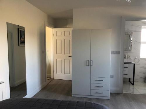 a bedroom with a white cabinet and a sink at Oak Tree Lodge in Westport