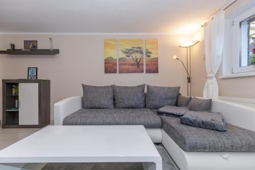a living room with a couch and a table at Ostseetraum in Kühlungsborn