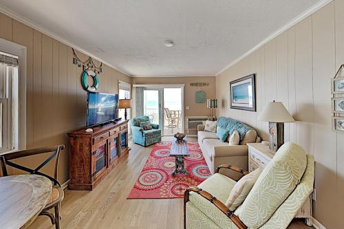 a living room with a couch and a tv at Ocean Pier #122 in Myrtle Beach