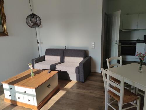 a living room with a couch and a table at Landapartments Smitmans in Kerken