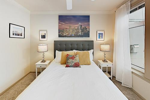 a bedroom with a large white bed with two lamps at Alaskan Dreams in Seattle