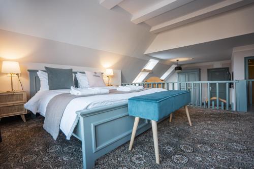a bedroom with a bed and a blue stool at Conacul Törzburg in Bran