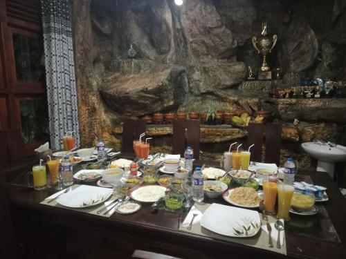 a table with plates of food on top of it at Princess of Dickoya Homestay in Hatton