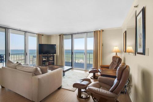 a living room with a couch and chairs and a television at Tristan Towers unit 5A in Pensacola Beach
