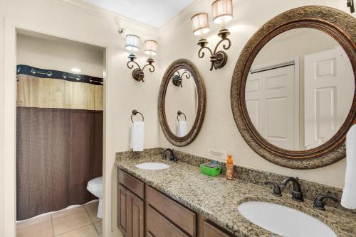 a bathroom with two sinks and a mirror at Tristan Towers unit 5A in Pensacola Beach