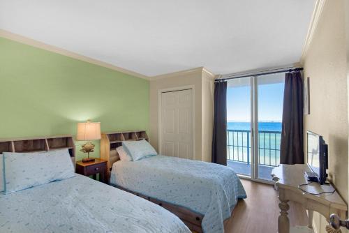 a hotel room with two beds and a large window at Tristan Towers unit 5A in Pensacola Beach