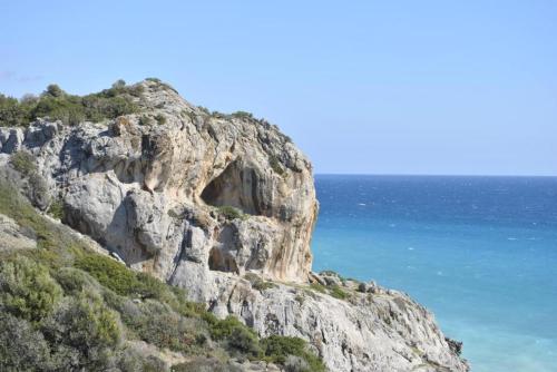 a rocky mountain with the ocean in the background at Chouzourakis Studios in Keratokampos
