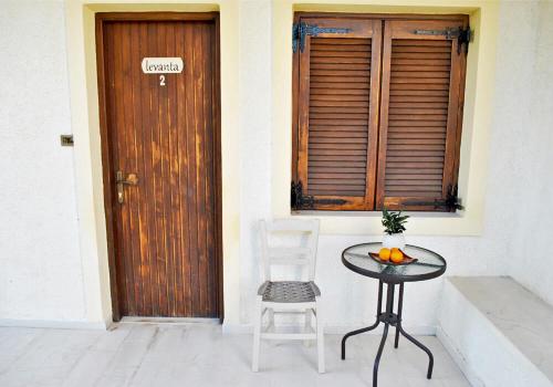 a table and a chair in front of a door at Chouzourakis Studios in Keratokampos