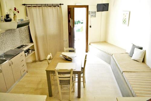 a small kitchen with a table and a dining room at Chouzourakis Studios in Keratokampos