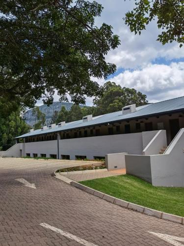 a large white building with a road in front of it at Avoca Vale Country Hotel in Louis Trichardt