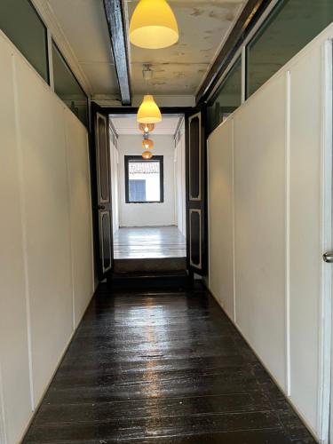 a corridor of an office building with a hallway at Layang Layang Guest House Melaka in Melaka