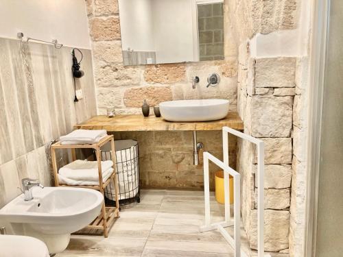 a bathroom with a sink and a toilet at Antica Pietra in Polignano a Mare