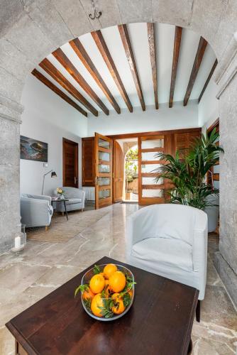 a bowl of oranges on a table in a living room at Finca Son Arnau in El Port de la Selva
