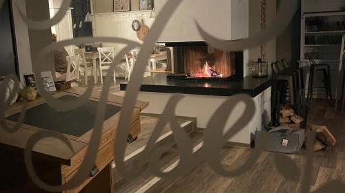 a living room with a fireplace in a kitchen at Café Ilse - Ferienwohnungen in Ranis